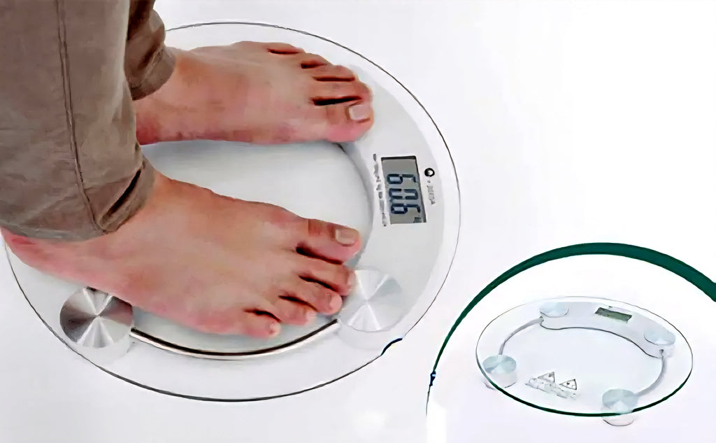 Person using digital glass bathroom scale